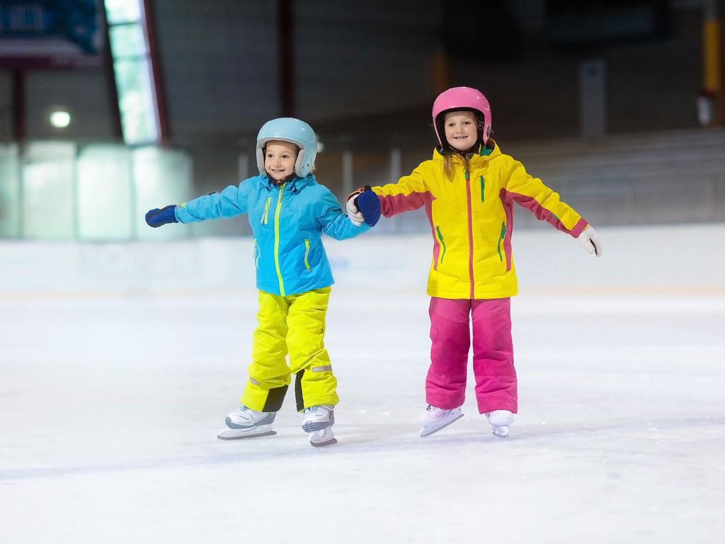 Children skating on indoor ice rink