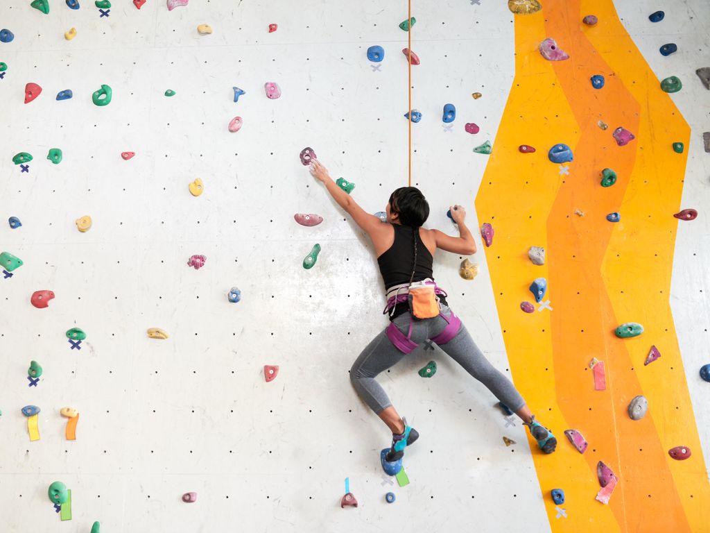 Woman climbing indoor